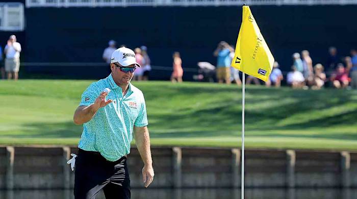 Ryan Fox acknowledges the crowd after picking his ball out of the hole after a hole in one at the 17th hole during the first round of the 2024 Players Championship on the Stadium Course at TPC Sawgrass in Ponte Vedra Beach, Fla.